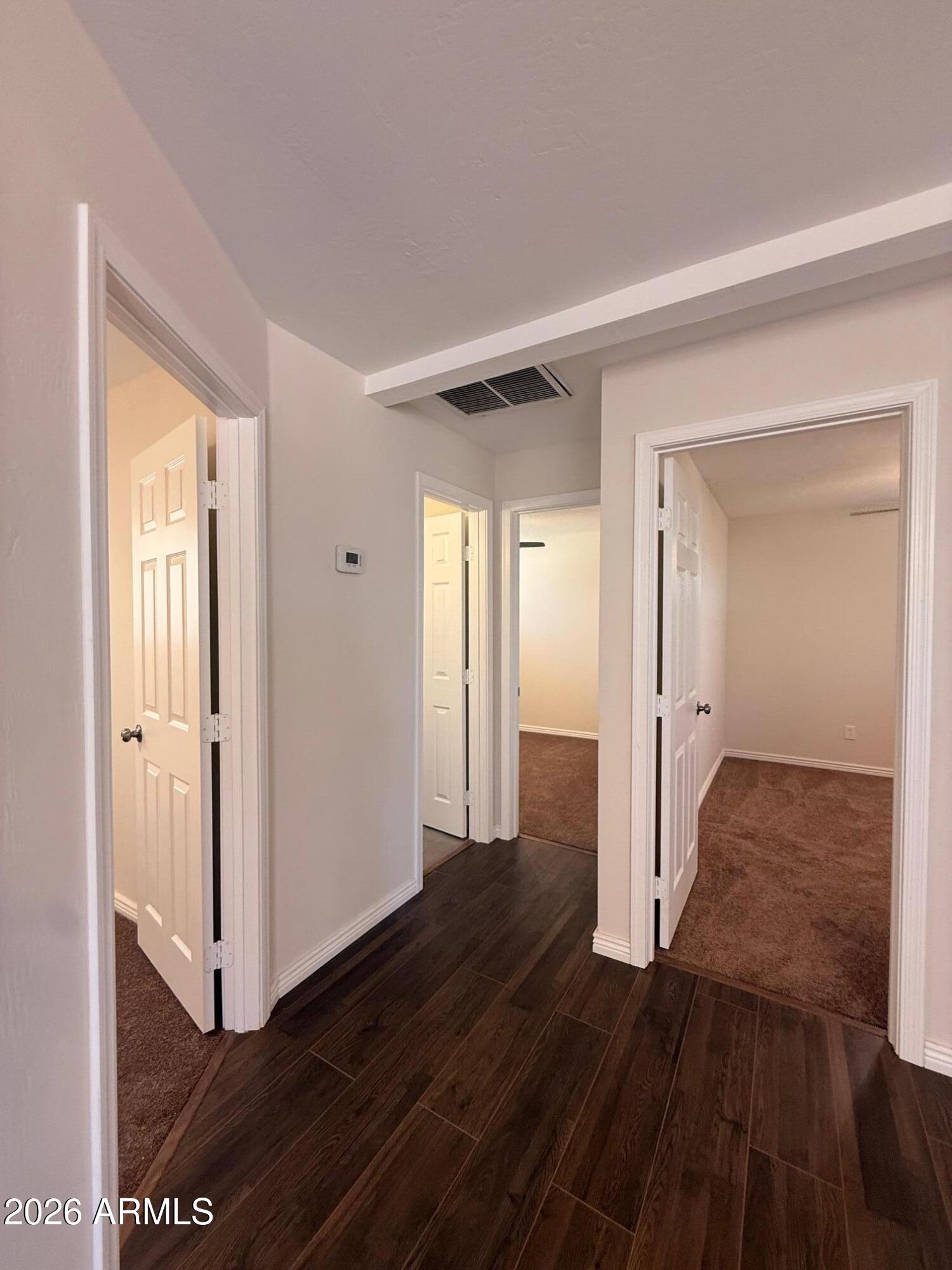 135 Rex Avenue Apache Junction, AZ 85120 - Photo 9 of 27 a view of a hallway with wooden floor