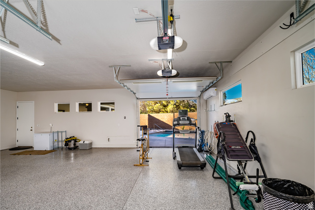 1283 North Gallen Road Santa Clara, UT 84765 - Photo 68 of 103 Garage with white refrigerator and a garage door opener, epoxy flooring.