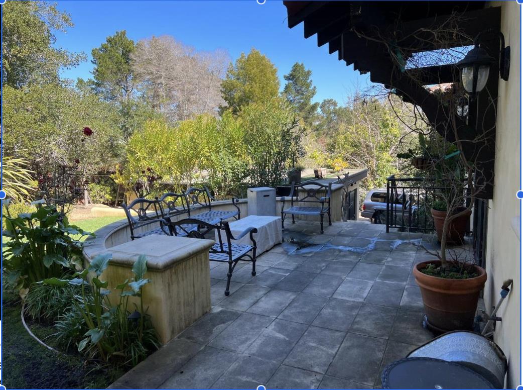 1120 Southdown Road Hillsborough, CA 94010 - Photo 10 of 12 a view of a patio with table and chairs potted plants and a large tree