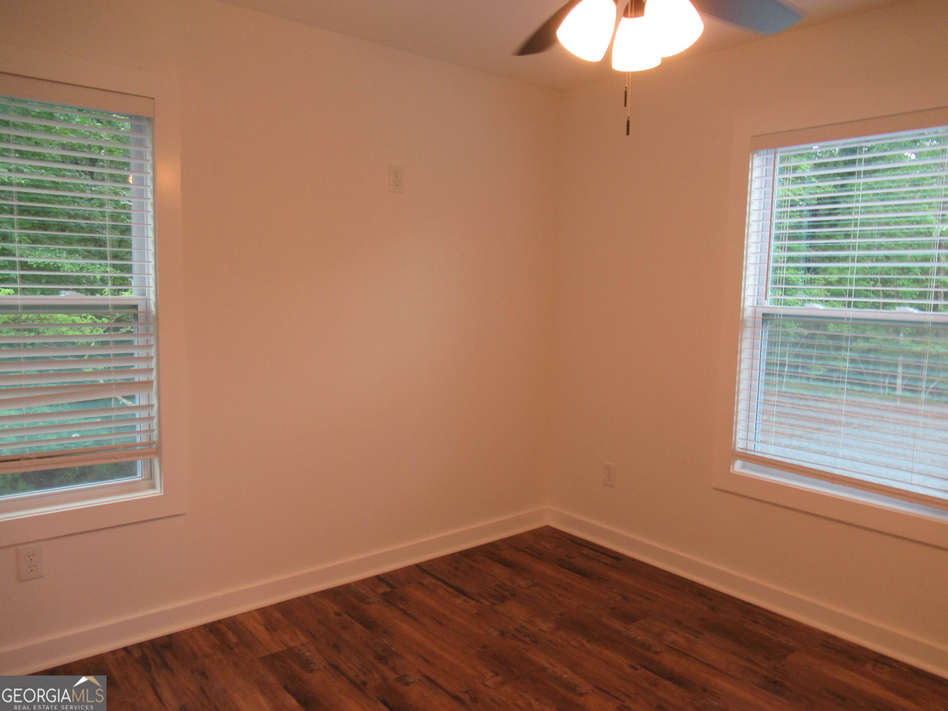 765 Old Kerns Road Dawsonville, GA 30534 - Photo 27 of 36 a view of an empty room with wooden floor and a window