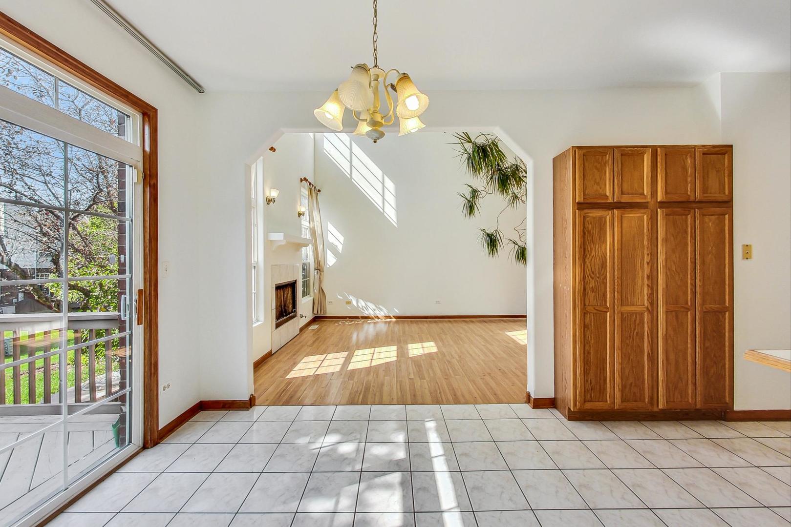 565 Goodwin Drive Bolingbrook, IL 60440 - Photo 11 of 44 a view of a livingroom with wooden floor and a chandelier