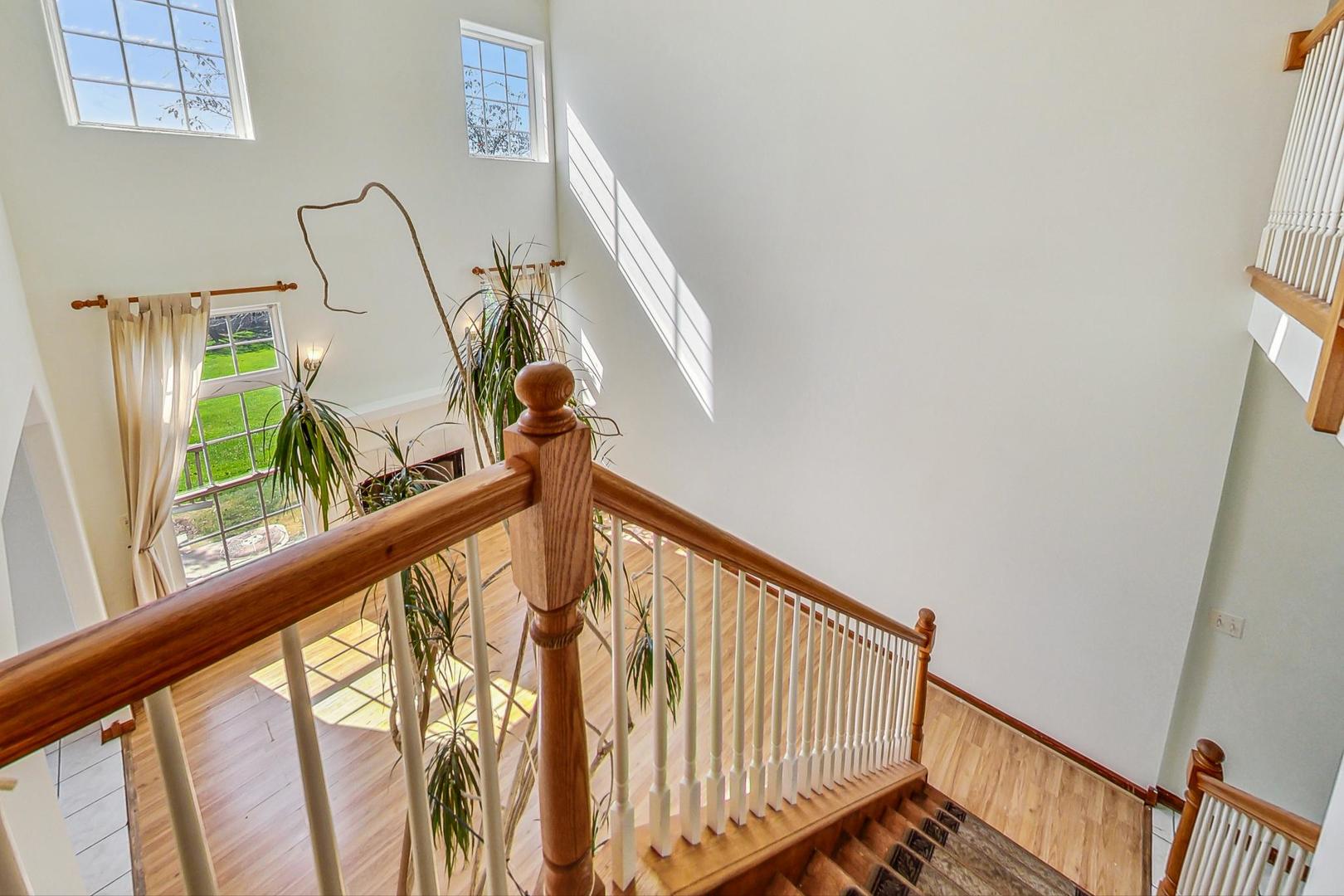 565 Goodwin Drive Bolingbrook, IL 60440 - Photo 16 of 44 a view of staircase with railing and white walls