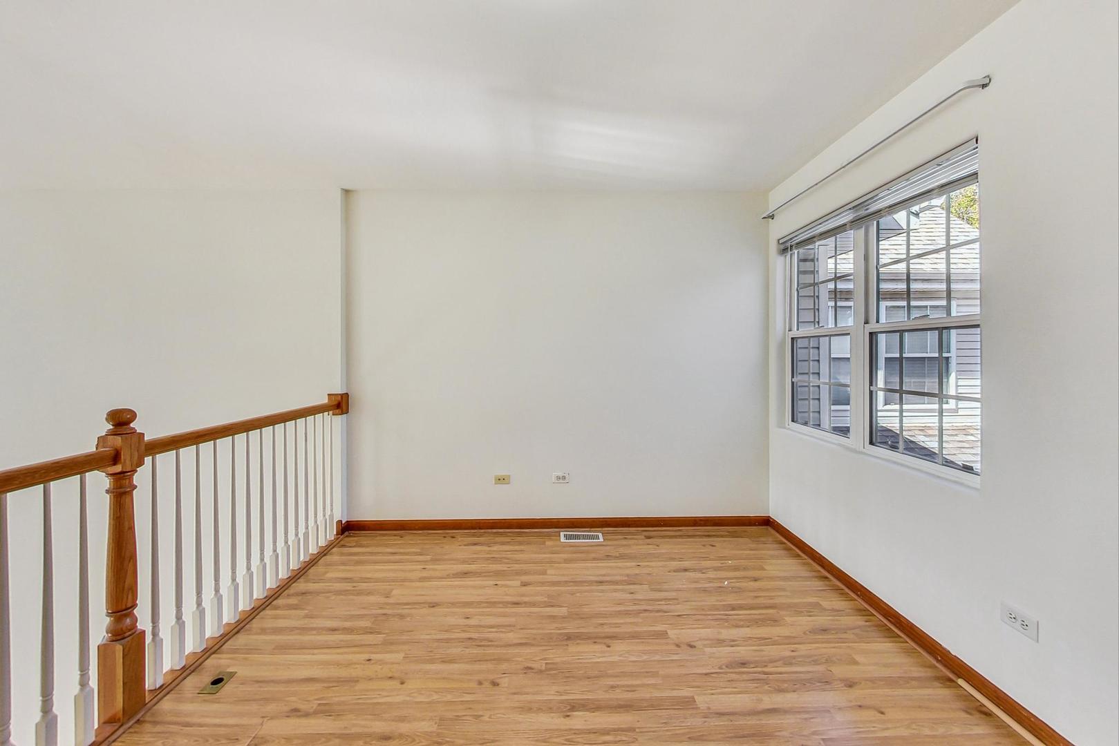 565 Goodwin Drive Bolingbrook, IL 60440 - Photo 17 of 44 a view of an empty room with wooden floor and a window