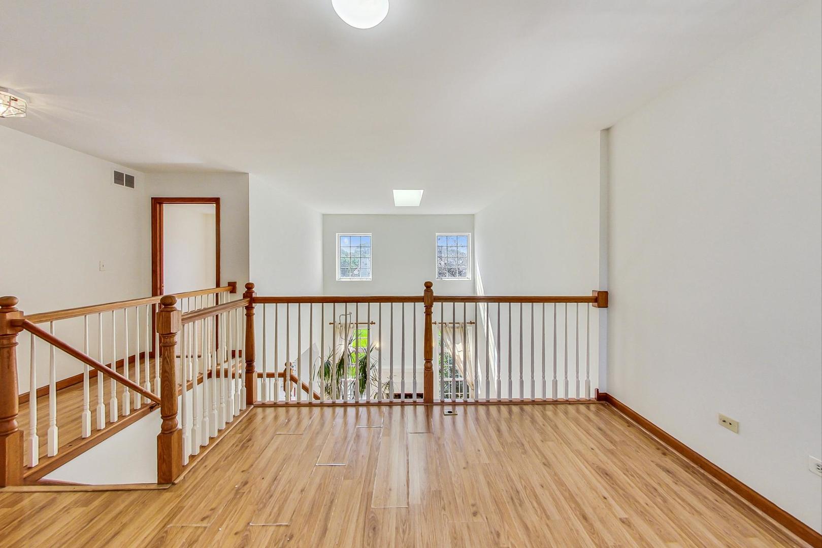 565 Goodwin Drive Bolingbrook, IL 60440 - Photo 18 of 44 a view of a hallway with wooden floor