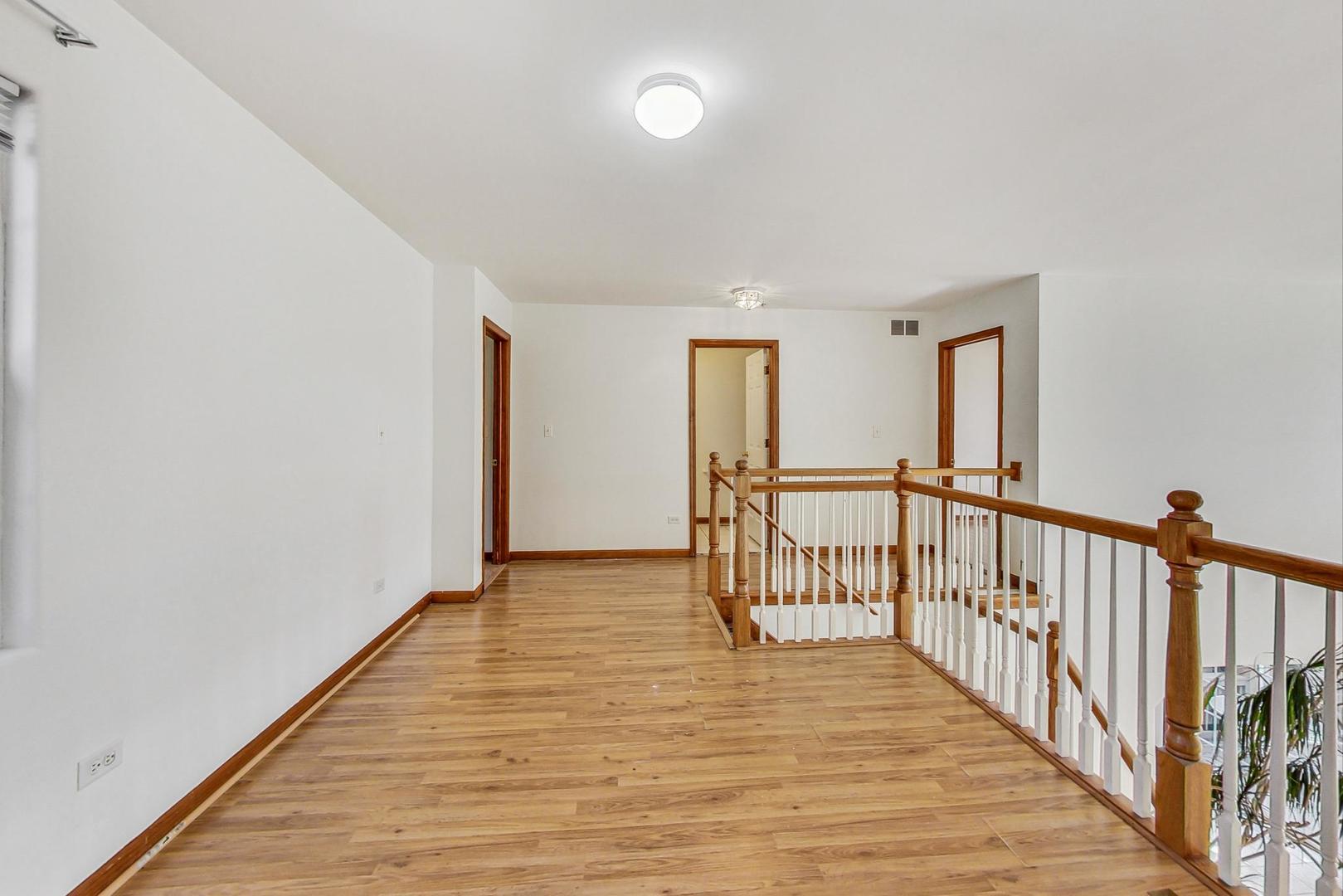 565 Goodwin Drive Bolingbrook, IL 60440 - Photo 19 of 44 a view of a hallway with wooden floor