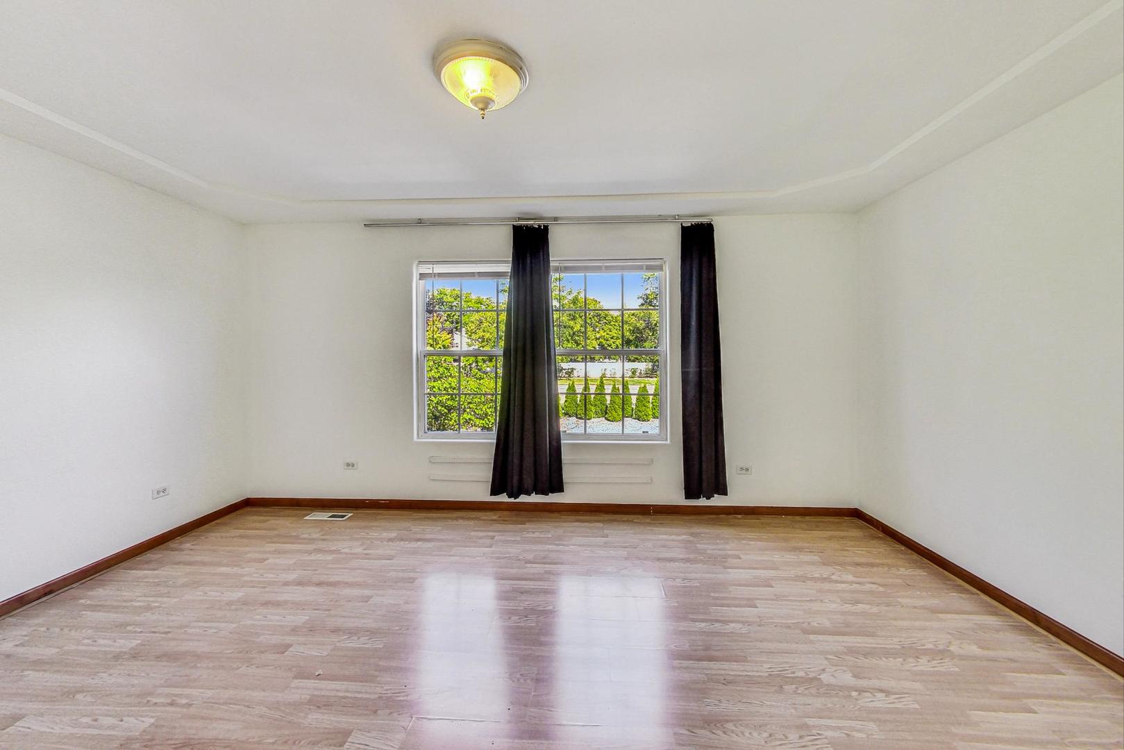 565 Goodwin Drive Bolingbrook, IL 60440 - Photo 20 of 44 a view of an empty room with wooden floor and a window