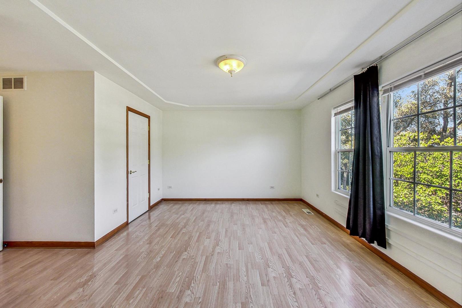 565 Goodwin Drive Bolingbrook, IL 60440 - Photo 21 of 44 a view of an empty room with wooden floor and a window