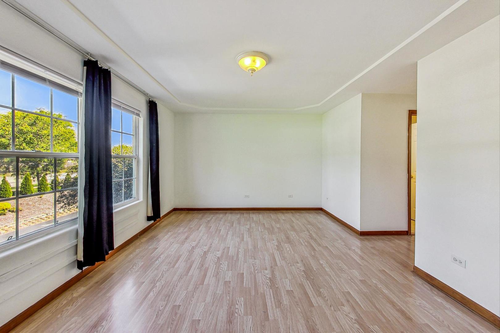 565 Goodwin Drive Bolingbrook, IL 60440 - Photo 22 of 44 a view of an empty room with wooden floor and a window