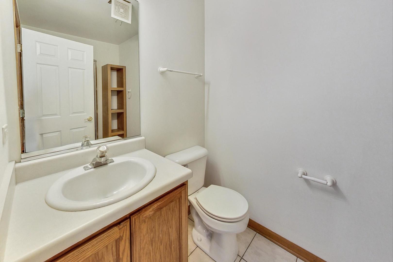 565 Goodwin Drive Bolingbrook, IL 60440 - Photo 24 of 44 a bathroom with a sink and a toilet