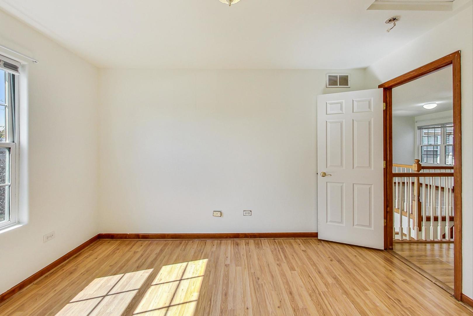 565 Goodwin Drive Bolingbrook, IL 60440 - Photo 27 of 44 a view of an empty room and wooden floor