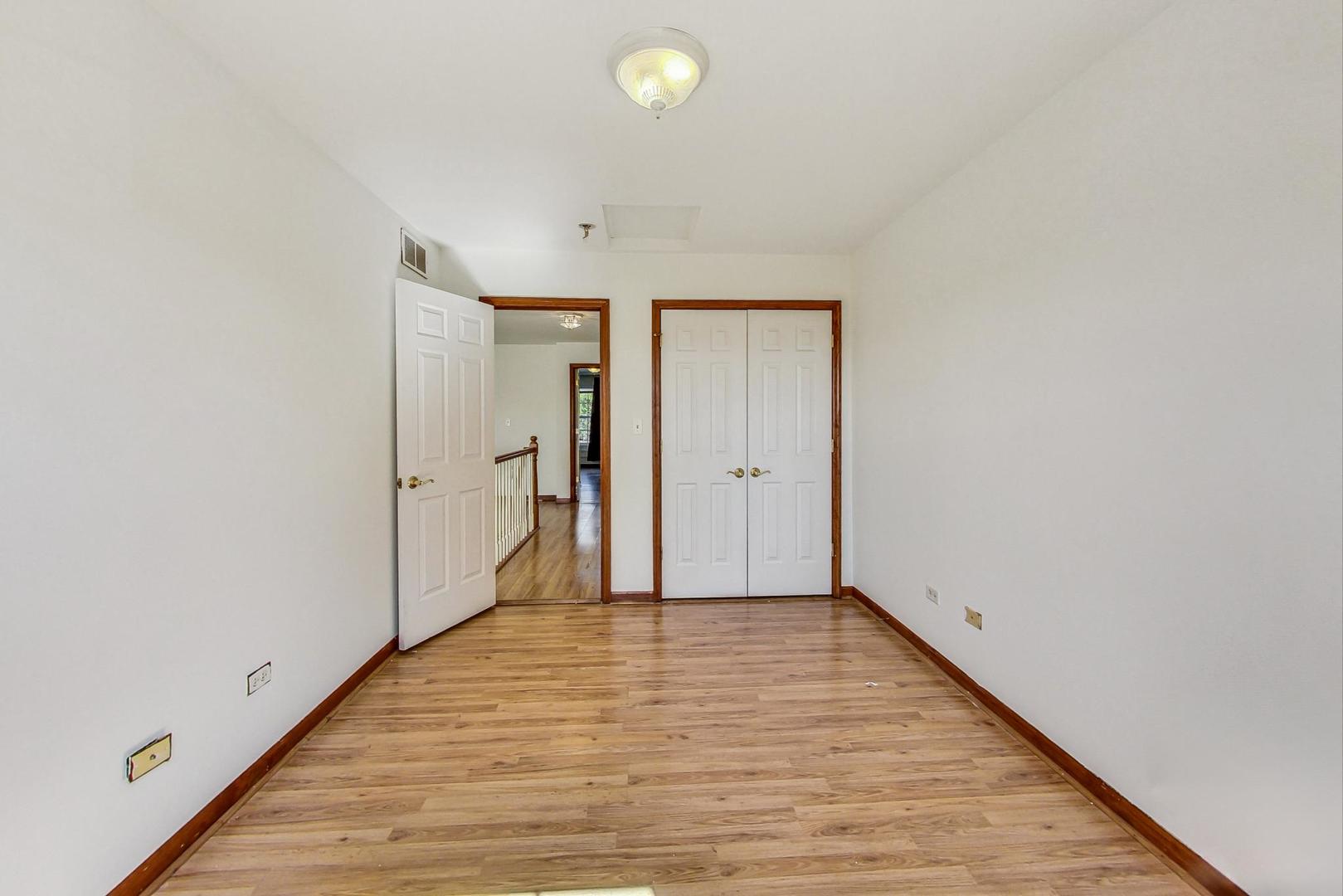 565 Goodwin Drive Bolingbrook, IL 60440 - Photo 28 of 44 a view of an empty room with wooden floor and a window