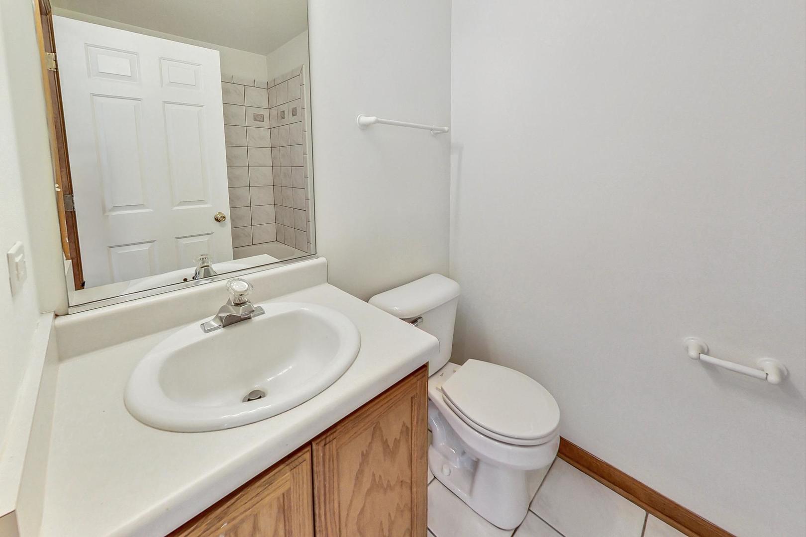 565 Goodwin Drive Bolingbrook, IL 60440 - Photo 29 of 44 a bathroom with a sink a toilet and shower
