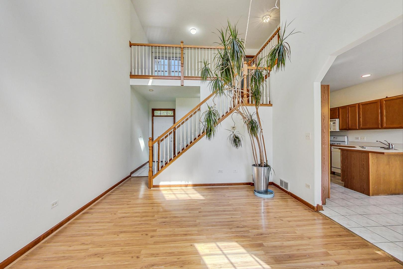 565 Goodwin Drive Bolingbrook, IL 60440 - Photo 8 of 44 a view of entryway and hall with wooden floor