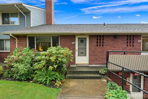 a front view of a house with a garden