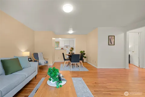 a dining room with furniture and wooden floor