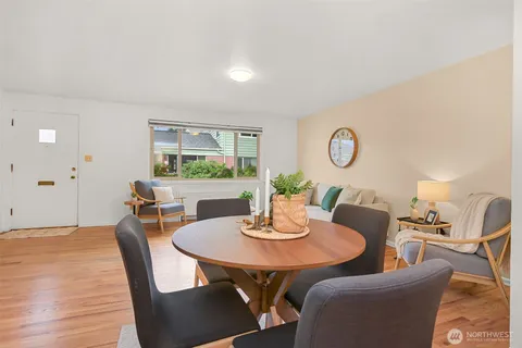 a view of a dining room with furniture and wooden floor