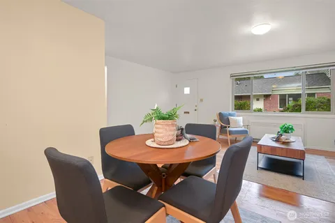 a dining room with furniture and wooden floor