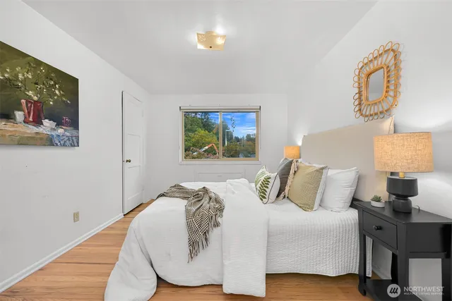 a bed sitting in a bedroom next to a window
