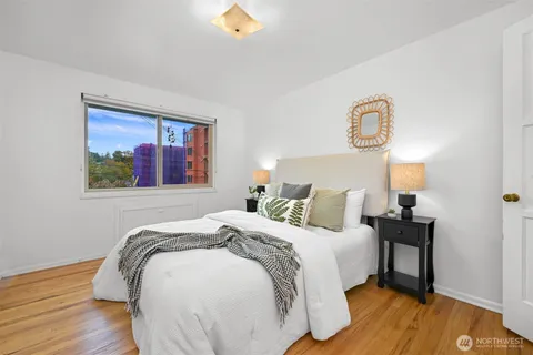 a large bed sitting in a bedroom and a table