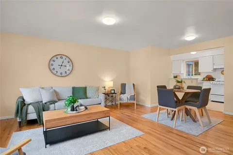 a living room with furniture and view of kitchen