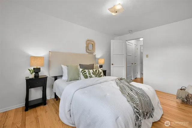 a bedroom with a bed and a painting on the wall