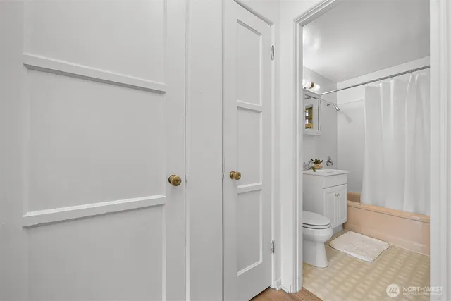 a kitchen with white cabinets and sink