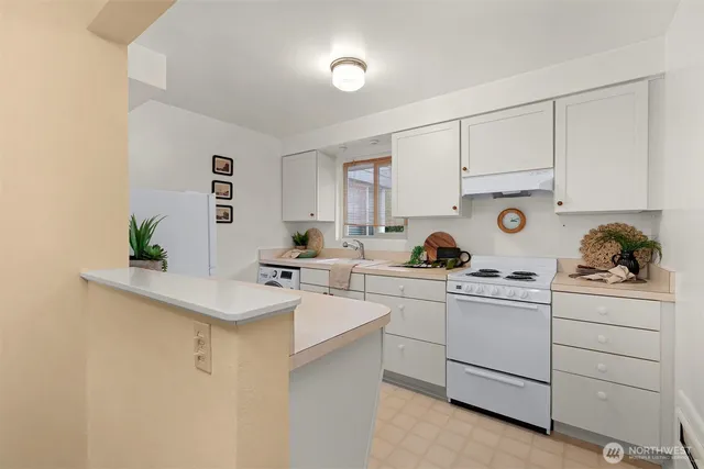 a kitchen with a sink cabinets and window