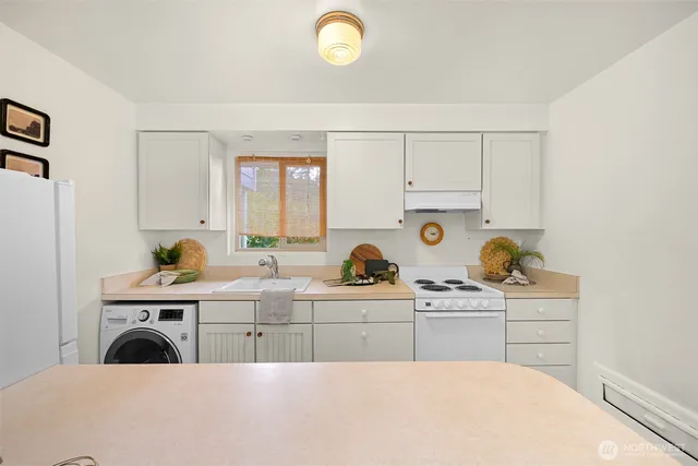 a kitchen with a stove and cabinets