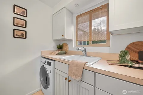 a kitchen with white cabinets and a sink