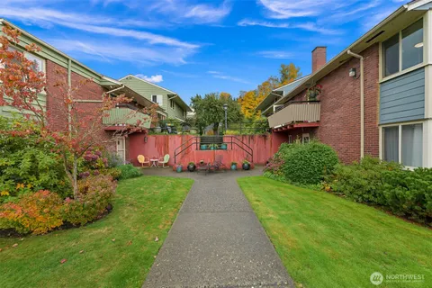 a view of a swimming pool with outdoor seating and plants