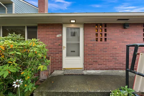 a view of a house with backyard sitting area and garden