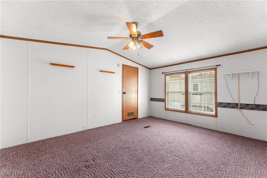 4455 Cleveland Road, Unit 6 Wooster, OH 44691 - Photo 15 of 40 Carpeted spare room with ceiling fan, lofted ceiling, a textured ceiling, and ornamental molding