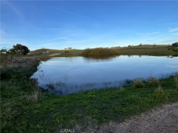 a view of a lake with a yard