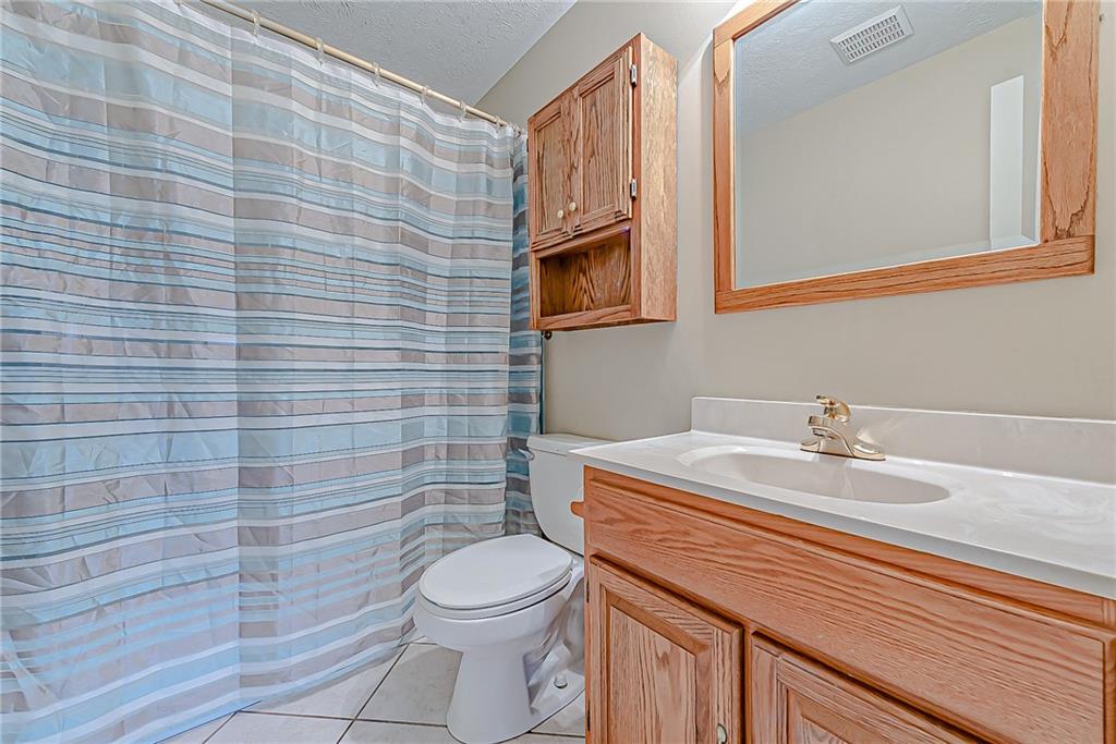 5830 Claridge Export Road Export, PA 15632 - Photo 18 of 25 a bathroom with a sink a toilet and mirror