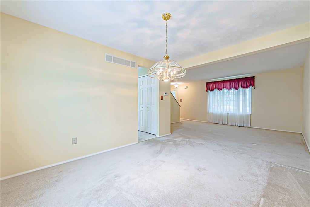 5830 Claridge Export Road Export, PA 15632 - Photo 6 of 25 a view of a hallway with a chandelier fan and wooden floor