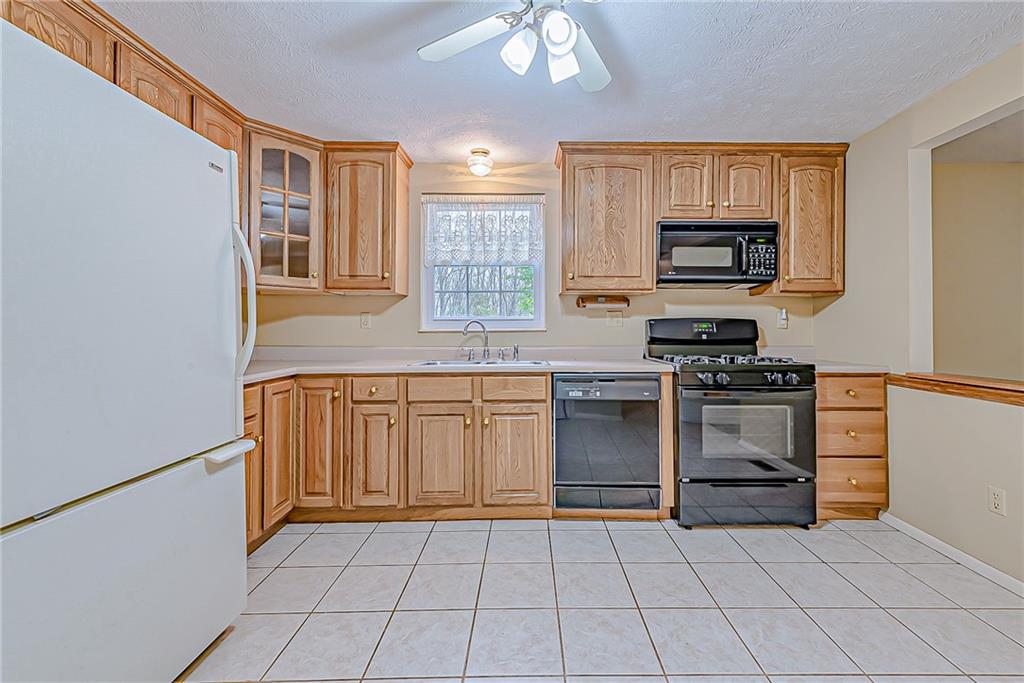 5830 Claridge Export Road Export, PA 15632 - Photo 9 of 25 a kitchen with stainless steel appliances a stove sink and microwave