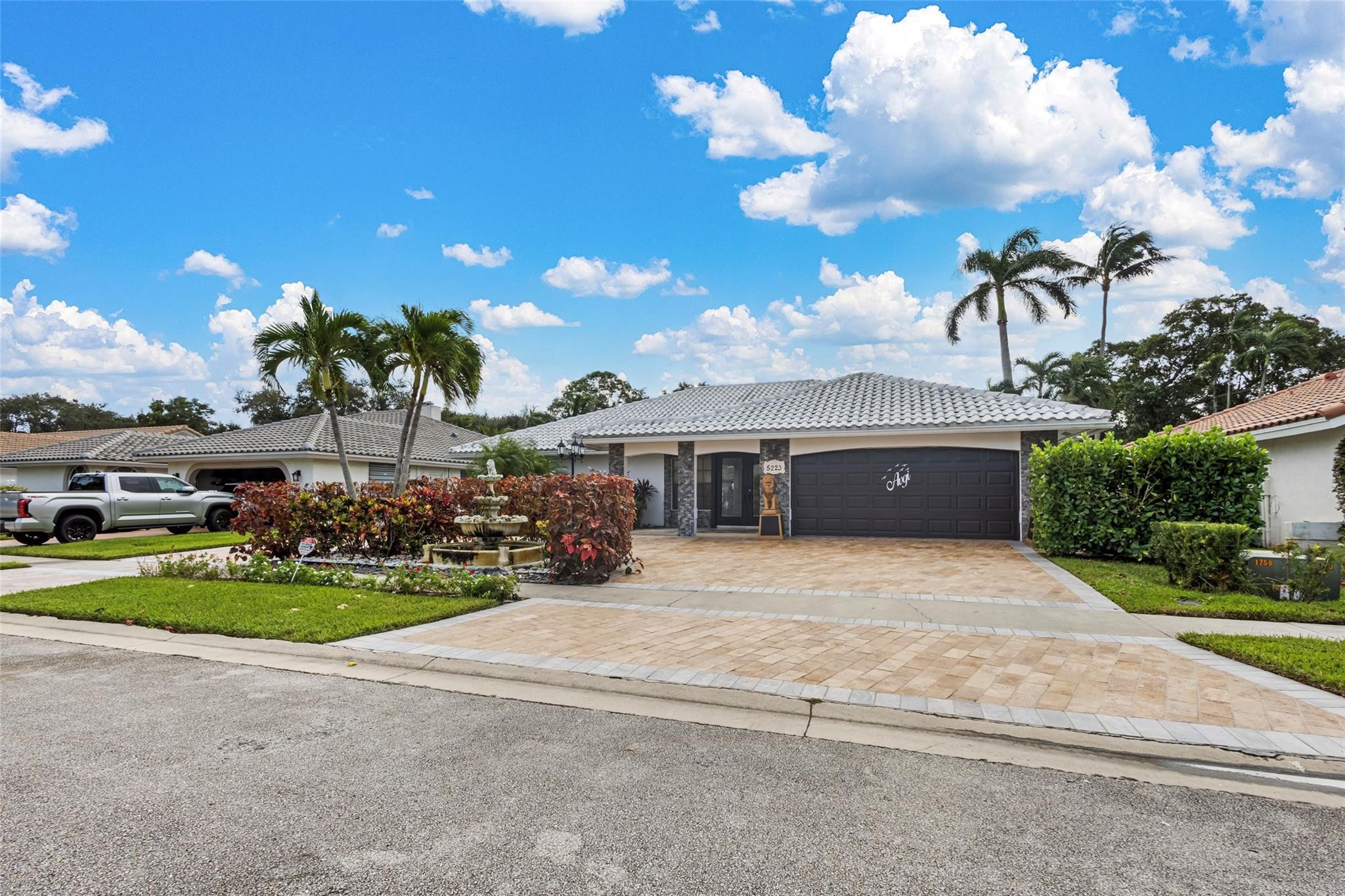 5223 Deerhurst Crescent Circle Boca Raton, FL 33486 - Photo 8 of 51 a front view of a house with a yard and a garage