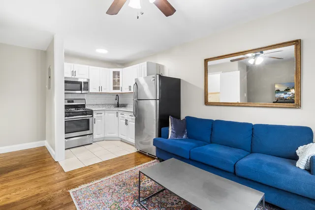 a kitchen with a refrigerator cabinets and wooden floor