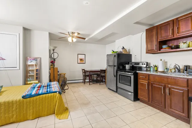 a kitchen with stainless steel appliances kitchen island granite countertop a sink and cabinets