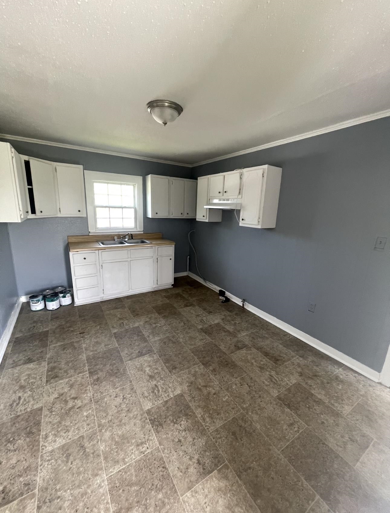 183 North Main Street Ripley, TN 38063 - Photo 3 of 8 a room with a cabinets and window