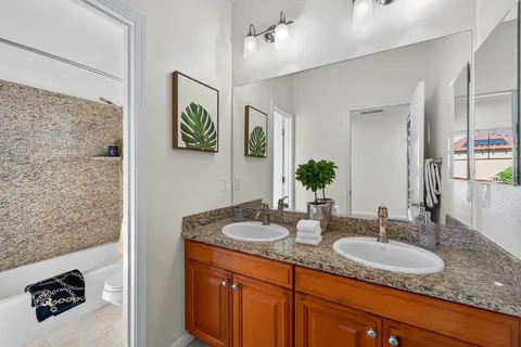 a bathroom with a sink double vanity and a mirror