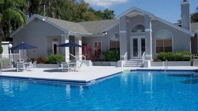 a view of a house with pool table and chairs