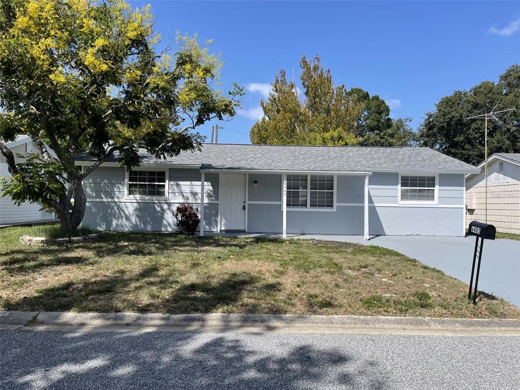 6403 Butte Avenue New Port Richey, FL 34653 - Photo 1 of 1 a front view of a house with a garden
