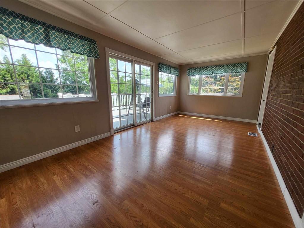 4971 Roberta Drive Pittsburgh, PA 15236 - Photo 10 of 27 an empty room with wooden floor and windows