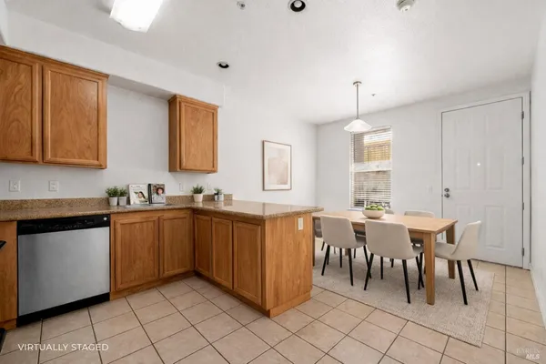 a large kitchen with cabinets table and chairs