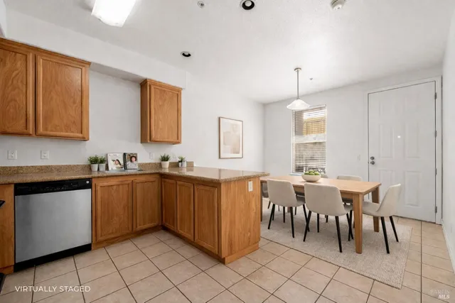 a large kitchen with cabinets table and chairs
