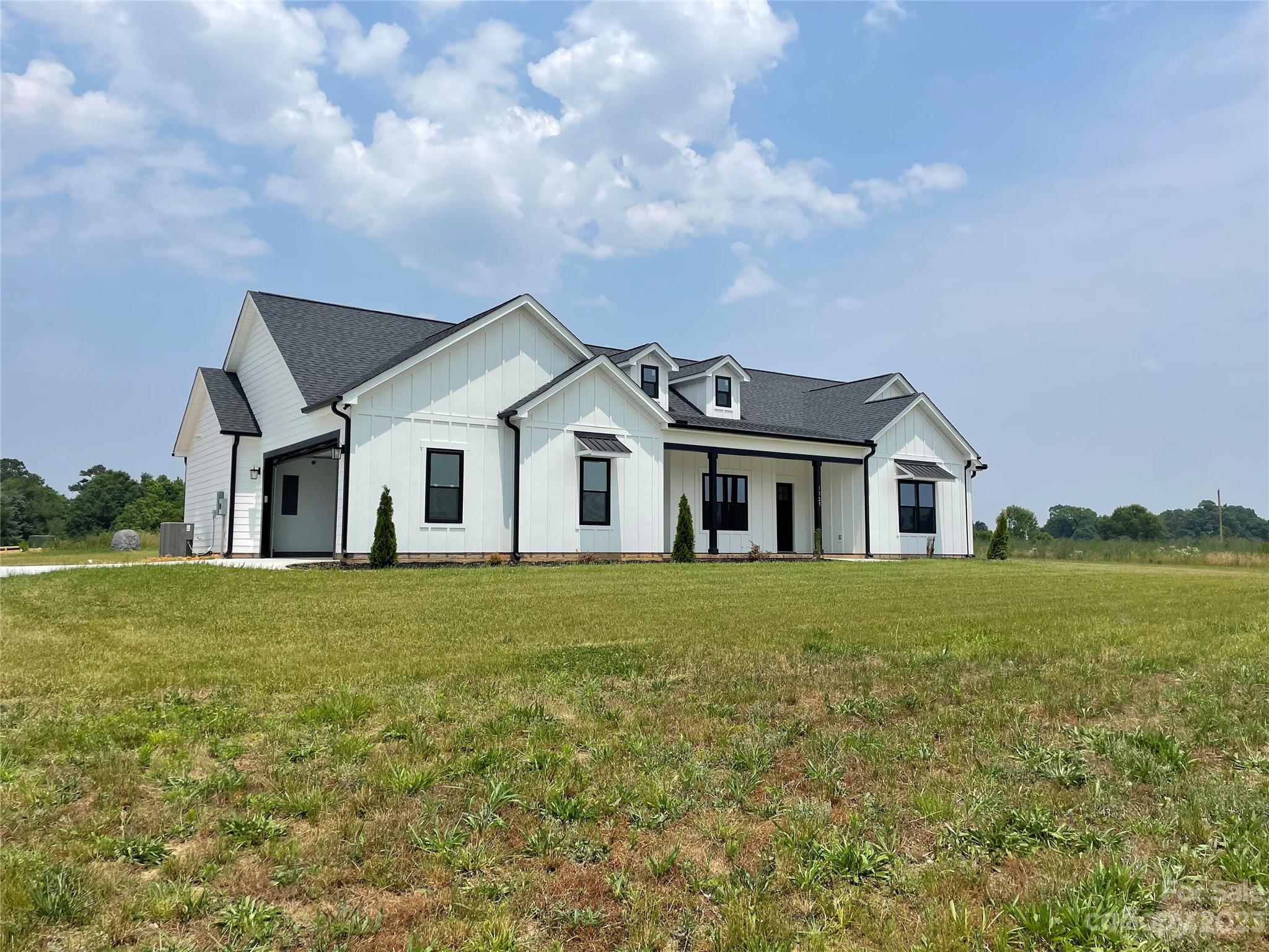 1327 Stack Road Monroe, NC 28112 - Photo 2 of 9 a front view of a house with a garden