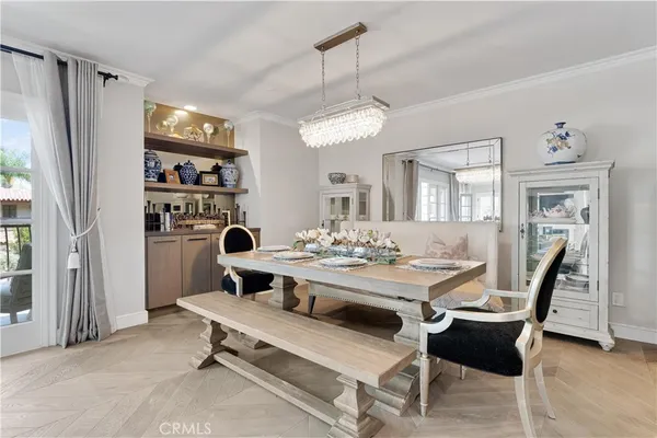 a view of a dining room with furniture and a chandelier
