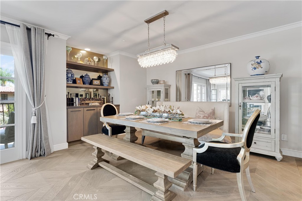 277 South Spalding Drive, Unit 201 Beverly Hills, CA 90212 - Photo 11 of 31 a view of a dining room with furniture and a chandelier