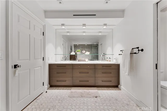 a bathroom with a double vanity sink mirror and